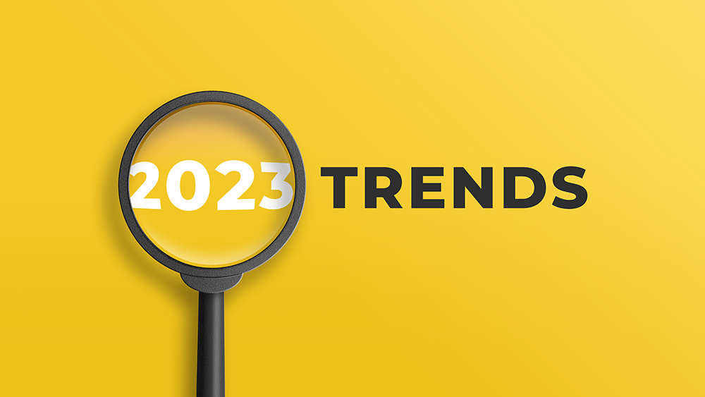 Forstørrelsesglass som zoomer inn over 2023 og så står det Trends 
